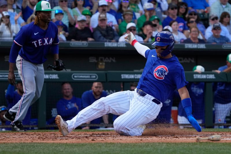 Mar 17, 2024; Mesa, Arizona, USA; Chicago Cubs right fielder Seiya Suzuki (27) scores a run against the Texas Rangers in the first inning at Sloan Park. Mandatory Credit: Rick Scuteri-USA TODAY Sports