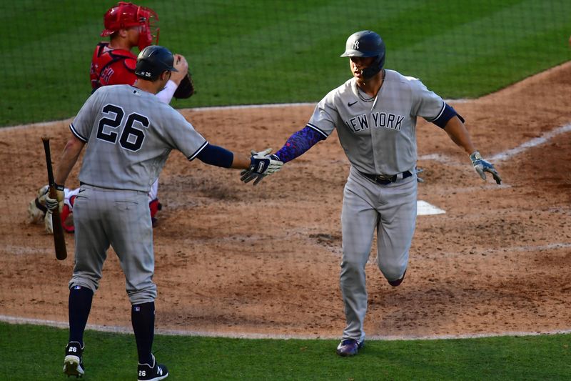 Jul 19, 2023; Anaheim, California, USA; New York Yankees designated hitter Giancarlo Stanton (27) is greeted by first baseman DJ LeMahieu (26) after hitting a solo home run against the Los Angeles Angels during the sixth inning at Angel Stadium. Mandatory Credit: Gary A. Vasquez-USA TODAY Sports