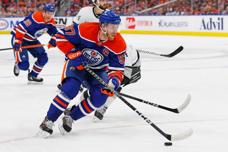 Apr 22, 2024; Edmonton, Alberta, CAN; Edmonton Oilers forward Connor McDavid (97) carries the puck around Los Angeles Kings defensemen Mikey Anderson (44) during the first period in game one of the first round of the 2024 Stanley Cup Playoffs at Rogers Place. Mandatory Credit: Perry Nelson-USA TODAY Sports