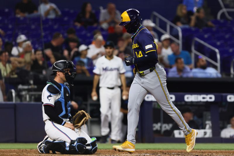 May 20, 2024; Miami, Florida, USA; Milwaukee Brewers second baseman Andruw Monasterio (14) scores after hitting a home run against the Miami Marlins during the fifth inning at loanDepot Park. Mandatory Credit: Sam Navarro-USA TODAY Sports