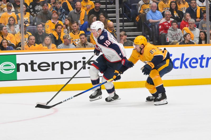 Oct 9, 2025; Nashville, Tennessee, USA; Nashville Predators defenseman Adam Wilsby (83) and Columbus Blue Jackets left wing Dmitri Voronkov (10) battle for the puck during the third period at Bridgestone Arena. Mandatory Credit: Steve Roberts-Imagn Images