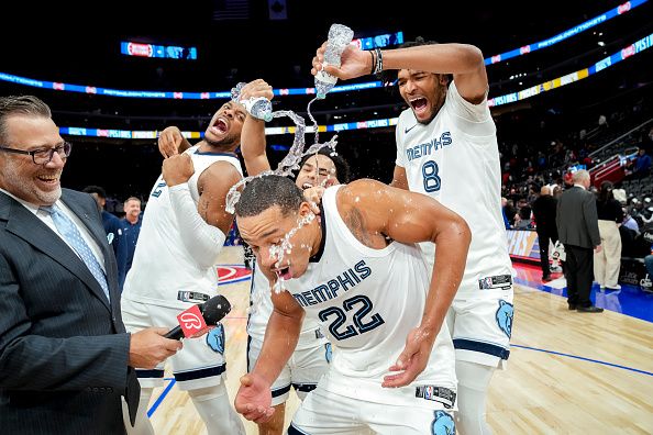 DETROIT, MICHIGAN - DECEMBER 06: Xavier Tillman #2, Jacob Gilyard #0 and Ziaire Williams #8 surprise Desmond Bane #22 of the Memphis Grizzlies during an interview after the game at Little Caesars Arena on December 06, 2023 in Detroit, Michigan. Bane scored a career-high 49 points. NOTE TO USER: User expressly acknowledges and agrees that, by downloading and or using this photograph, User is consenting to the terms and conditions of the Getty Images License Agreement. (Photo by Nic Antaya/Getty Images)