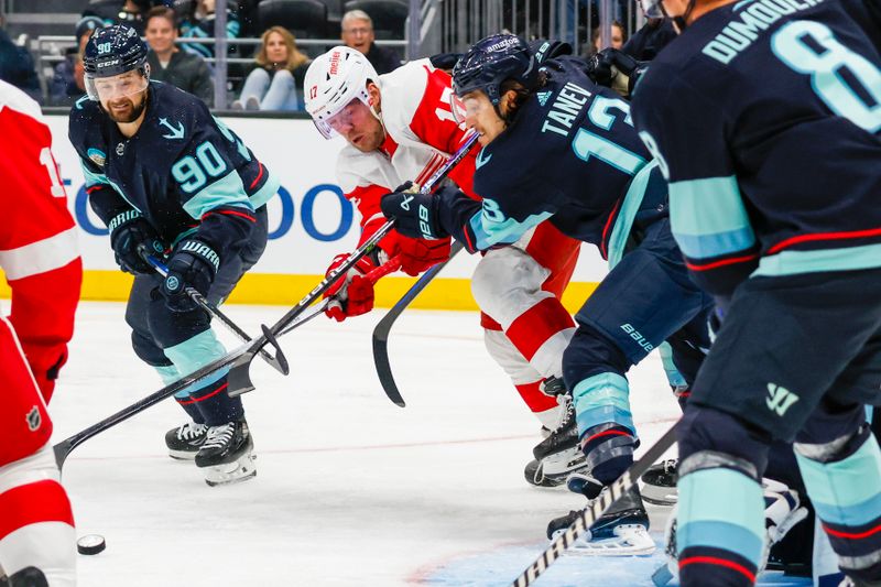 Feb 19, 2024; Seattle, Washington, USA; Seattle Kraken left wing Brandon Tanev (13) disrupts a shot attempt by Detroit Red Wings right wing Daniel Sprong (17) during the third period at Climate Pledge Arena. Mandatory Credit: Joe Nicholson-USA TODAY Sports