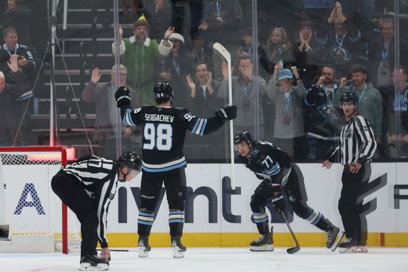 Dec 12, 2025; Salt Lake City, Utah, USA; Utah Mammoth defenseman Mikhail Sergachev (98) reacts to an open net goal scored by right wing JJ Peterka (77) during the third period of the game against the Seattle Kraken at Delta Center. Mandatory Credit: Rob Gray-Imagn Images