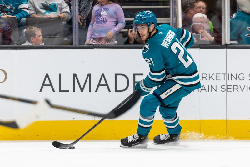 Nov 18, 2024; San Jose, California, USA; San Jose Sharks center Alexander Wennberg (21) passes the puck during the second period against the Detroit Red Wings at SAP Center at San Jose. Mandatory Credit: Bob Kupbens-Imagn Images