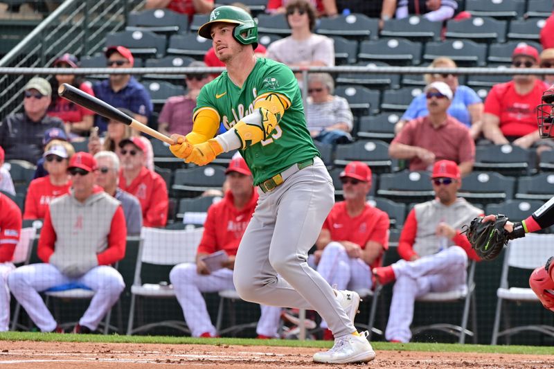 Mar 6, 2024; Tempe, Arizona, USA;  Oakland Athletics left fielder Brent Rooker (25) singles in the first inning against the Los Angeles Angels during a spring training game at Tempe Diablo Stadium. Mandatory Credit: Matt Kartozian-USA TODAY Sports