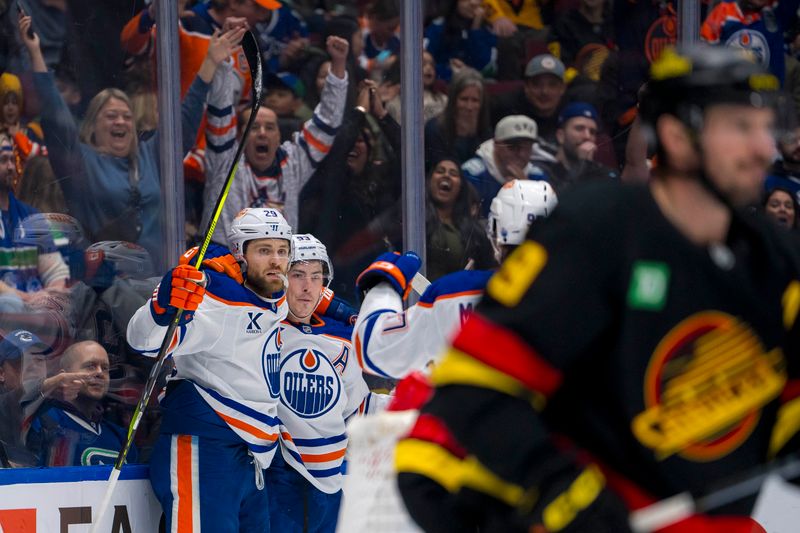 Nov 9, 2024; Vancouver, British Columbia, CAN; Edmonton Oilers forward Leon Draisaitl (29) and forward Ryan Nugent-Hopkins (93) celebrate Draisaitl’s goal against the Vancouver Canucks during the first period at Rogers Arena. Mandatory Credit: Bob Frid-Imagn Images