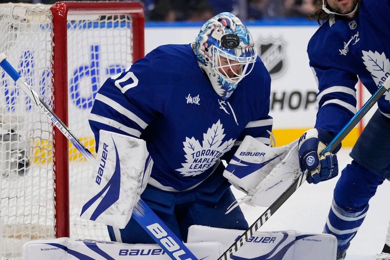 Jan 14, 2025; Toronto, Ontario, CAN; Toronto Maple Leafs goaltender Joseph Woll (60) has a puck go off his helmet during the second period against the Dallas Stars at Scotiabank Arena. Mandatory Credit: John E. Sokolowski-Imagn Images