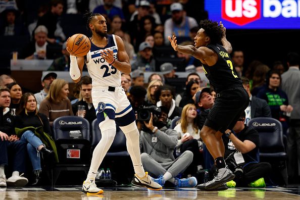 MINNEAPOLIS, MINNESOTA - NOVEMBER 30: Troy Brown Jr. #23 of the Minnesota Timberwolves looks to pass while Collin Sexton #2 of the Utah Jazz defends in the second quarter at Target Center on November 30, 2023 in Minneapolis, Minnesota. NOTE TO USER: User expressly acknowledges and agrees that, by downloading and or using this photograph, User is consenting to the terms and conditions of the Getty Images License Agreement. (Photo by David Berding/Getty Images)