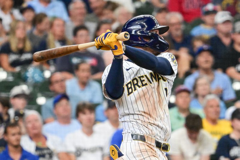 Jul 28, 2024; Milwaukee, Wisconsin, USA; Milwaukee Brewers second baseman Brice Turang (2) hits a single to drive in a run in the fourth inning against the Miami Marlins at American Family Field. Mandatory Credit: Benny Sieu-USA TODAY Sports