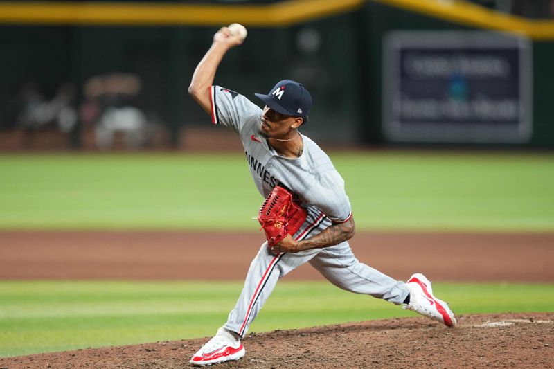 Jun 26, 2024; Phoenix, Arizona, USA; Minnesota Twins pitcher Ronny Henriquez (31) pitches against the Arizona Diamondbacks during the ninth inning at Chase Field. Mandatory Credit: Joe Camporeale-USA TODAY Sports