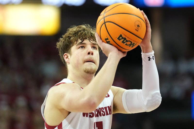 Jan 28, 2023; Madison, Wisconsin, USA;  Wisconsin Badgers guard Max Klesmit (11) shoots a free throw during the second half against the Illinois Fighting Illini at the Kohl Center. Mandatory Credit: Kayla Wolf-USA TODAY Sports