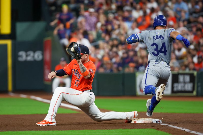 Aug 30, 2024; Houston, Texas, USA; Kansas City Royals catcher Freddy Fermin (34) is thrown out at first s Houston Astros first baseman Victor Caratini (17) scoops the ball in the fifth inning at Minute Maid Park. Mandatory Credit: Thomas Shea-USA TODAY Sports