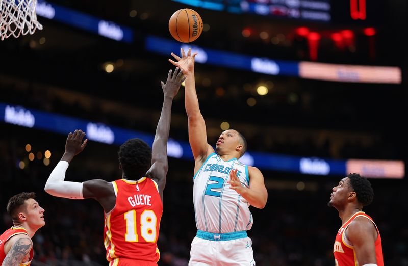 ATLANTA, GEORGIA - APRIL 10:  Grant Williams #2 of the Charlotte Hornets attempts a shot against Mouhamed Gueye #18 of the Atlanta Hawks during the fourth quarter at State Farm Arena on April 10, 2024 in Atlanta, Georgia.  NOTE TO USER: User expressly acknowledges and agrees that, by downloading and/or using this photograph, user is consenting to the terms and conditions of the Getty Images License Agreement.  (Photo by Kevin C. Cox/Getty Images)