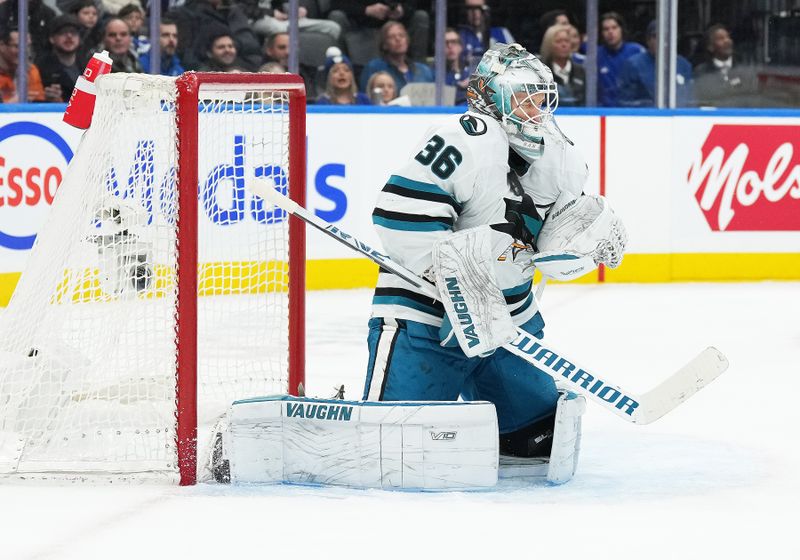 Jan 9, 2024; Toronto, Ontario, CAN; San Jose Sharks goaltender Kaapo Kahkonen (36) stops the puck against the Toronto Maple Leafs during the first period at Scotiabank Arena. Mandatory Credit: Nick Turchiaro-USA TODAY Sports