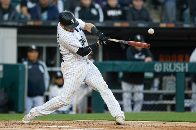 Apr 28, 2023; Chicago, Illinois, USA; Chicago White Sox third baseman Jake Burger (30) singles against the Tampa Bay Rays during the fourth inning at Guaranteed Rate Field. Mandatory Credit: Kamil Krzaczynski-USA TODAY Sports