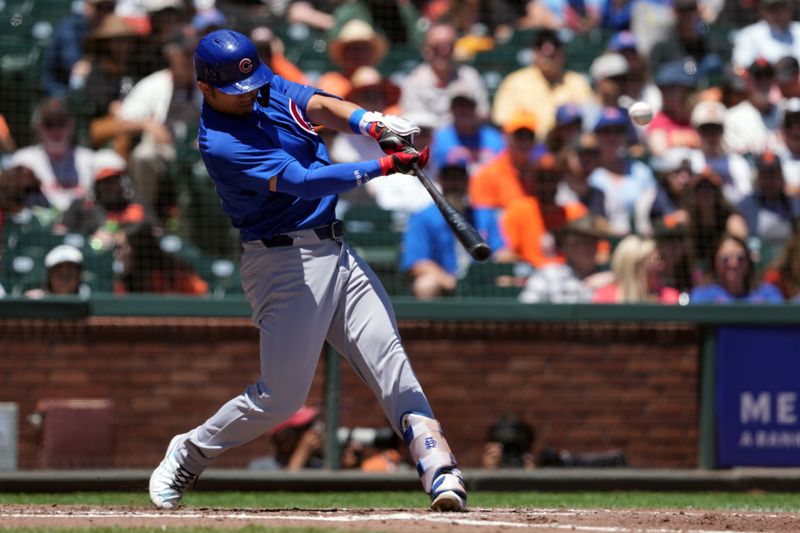 Jun 27, 2024; San Francisco, California, USA; Chicago Cubs left fielder Seiya Suzuki (27) hits an RBI triple against the San Francisco Giants during the third inning at Oracle Park. Mandatory Credit: Darren Yamashita-USA TODAY Sports