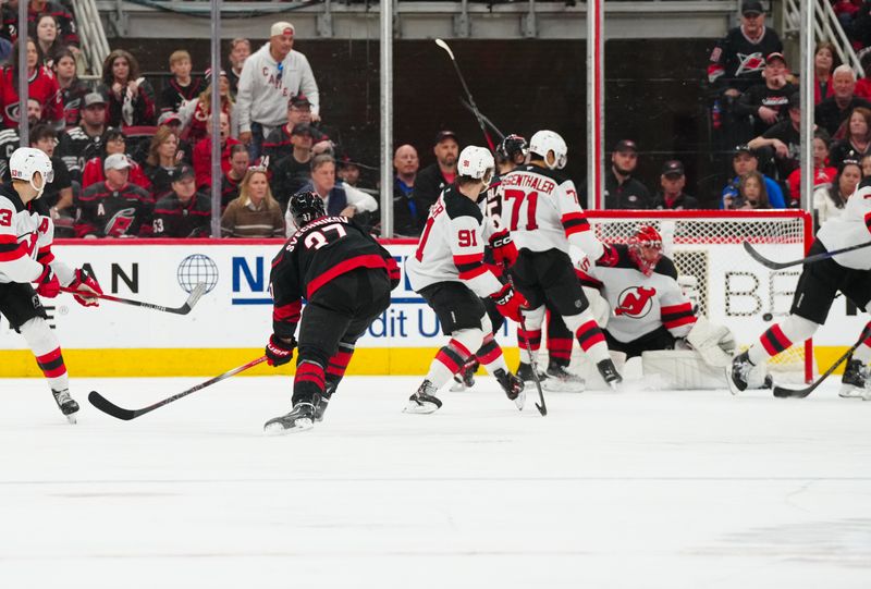 Apr 29, 2025; Raleigh, North Carolina, USA; Carolina Hurricanes right wing Andrei Svechnikov (37) scores a goal past New Jersey Devils goaltender Jacob Markstrom (25) during the second period in game five of the first round of the 2025 Stanley Cup Playoffs at Lenovo Center. Mandatory Credit: James Guillory-Imagn Images