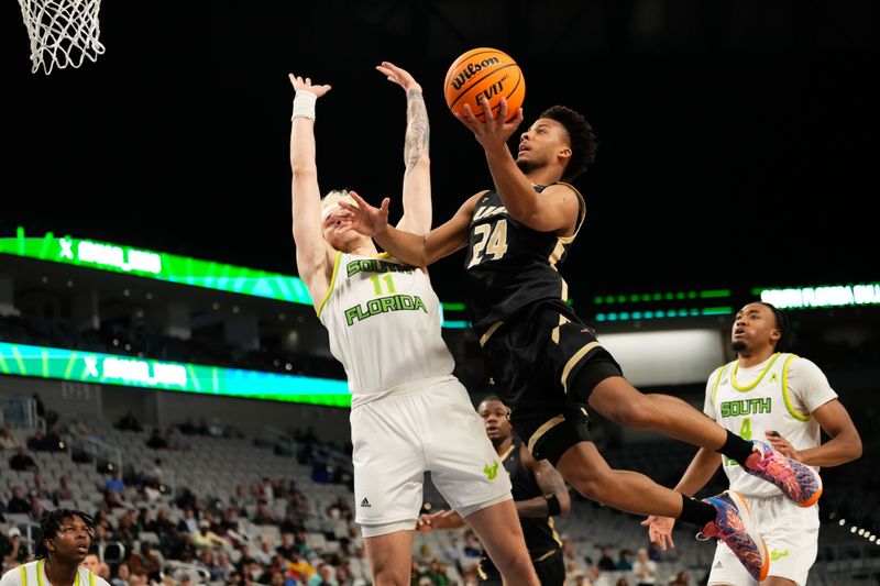 Mar 16, 2024; Fort Worth, TX, USA;  UAB Blazers guard Efrem Johnson (24) drives to the basket for a score against South Florida Bulls forward Kasean Pryor (11) during the second half at Dickies Arena. Mandatory Credit: Chris Jones-USA TODAY Sports