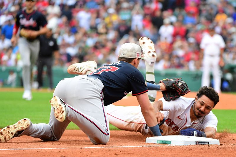 May 18, 2025; Boston, Massachusetts, USA;  Atlanta Braves third baseman Austin Riley (27) tags out Boston Red Sox second baseman David Hamilton (17) during the fourth inning at Fenway Park. Mandatory Credit: Bob DeChiara-Imagn Images
