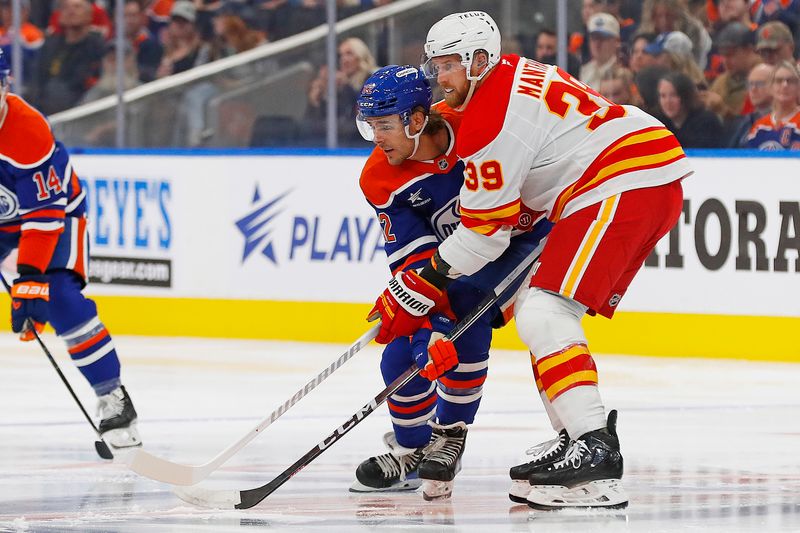 Sep 23, 2024; Edmonton, Alberta, CAN; Calgary Flames forward Antony Mantha (39) and Edmonton Oilers forward Raphael Lavoie (62) battle for position during the first period at Rogers Place. Mandatory Credit: Perry Nelson-Imagn Images