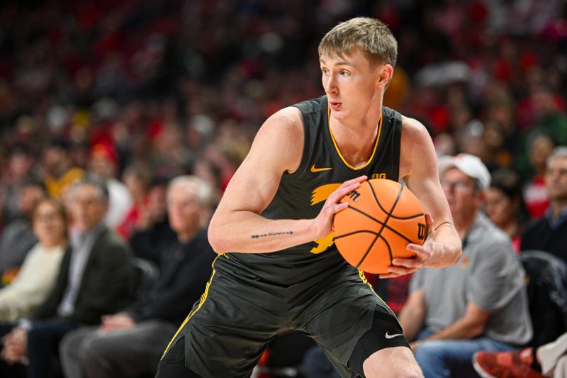 Feb 14, 2024; College Park, Maryland, USA;  Iowa Hawkeyes guard Josh Dix (4) make a move towards the basket during the first half against the Iowa Hawkeyes at Xfinity Center. Mandatory Credit: Tommy Gilligan-USA TODAY Sports