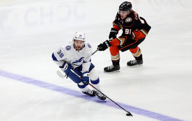 Mar 24, 2024; Anaheim, California, USA; Tampa Bay Lightning left wing Brandon Hagel (38) skates past Anaheim Ducks center Leo Carlsson (91) during the third period at Honda Center. Mandatory Credit: Jason Parkhurst-USA TODAY Sports