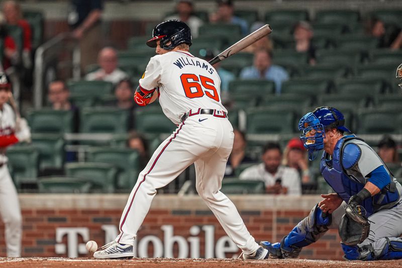 May 15, 2024; Cumberland, Georgia, USA; Atlanta Braves pinch hitter Luke Williams (65) is hit by a pitch against the Chicago Cubs during the ninth inning at Truist Park. Mandatory Credit: Dale Zanine-USA TODAY Sports