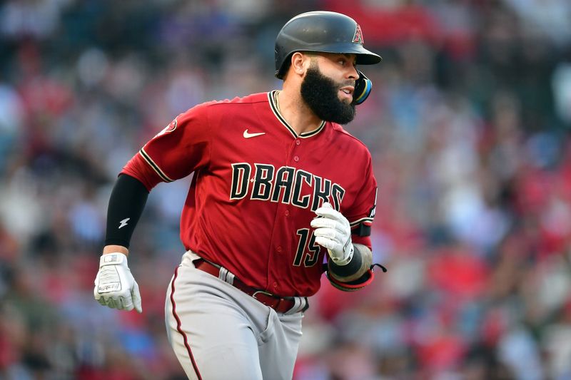 Jul 1, 2023; Anaheim, California, USA; Arizona Diamondbacks third baseman Emmanuel Rivera (15) runs after hitting a single against the Los Angeles Angels during the second inning at Angel Stadium. Mandatory Credit: Gary A. Vasquez-USA TODAY Sports