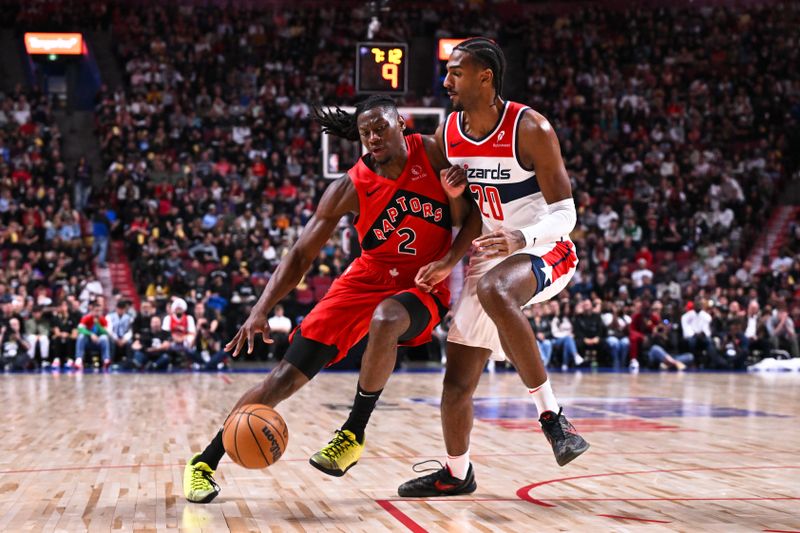 MONTREAL, CANADA - OCTOBER 06: Jonathan Mogbo #2 of the Toronto Raptors dribbles the ball against Alex Sarr #20 of the Washington Wizards during the first half of a preseason NBA game at the Bell Centre on October 6, 2024 in Montreal, Quebec, Canada. NOTE TO USER: User expressly acknowledges and agrees that, by downloading and or using this photograph, User is consenting to the terms and conditions of the Getty Images License Agreement. (Photo by Minas Panagiotakis/Getty Images)