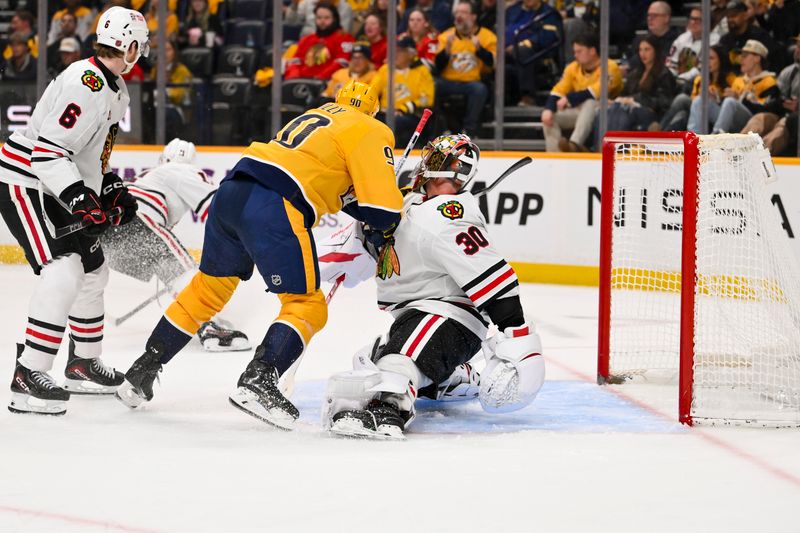 Feb 26, 2026; Nashville, Tennessee, USA;  Nashville Predators center Ryan O'Reilly (90) collides with Chicago Blackhawks goaltender Spencer Knight (30) during the third period at Bridgestone Arena. Mandatory Credit: Steve Roberts-Imagn Images