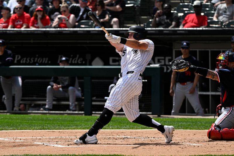 May 1, 2024; Chicago, Illinois, USA; Chicago White Sox first base Andrew Vaughn (25) hits an RBI single against the Minnesota Twins during the first inning at Guaranteed Rate Field. Mandatory Credit: Matt Marton-USA TODAY Sports