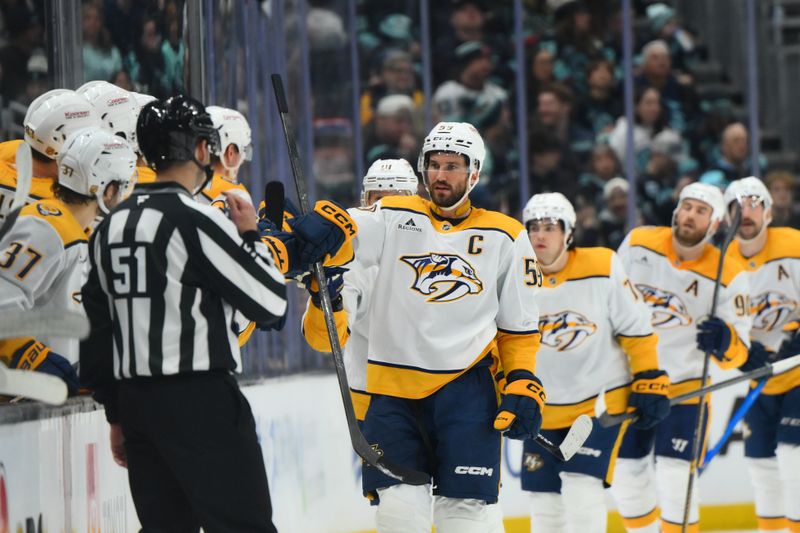Jan 1, 2026; Seattle, Washington, USA; Nashville Predators defenseman Roman Josi (59) celebrates with the bench after scoring a goal against the Seattle Kraken during the second period at Climate Pledge Arena. Mandatory Credit: Steven Bisig-Imagn Images