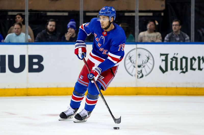 Jan 2, 2024; New York, New York, USA; New York Rangers defenseman K'Andre Miller (79) looks to pass against the Carolina Hurricanes during the second period at Madison Square Garden. Mandatory Credit: Danny Wild-USA TODAY Sports