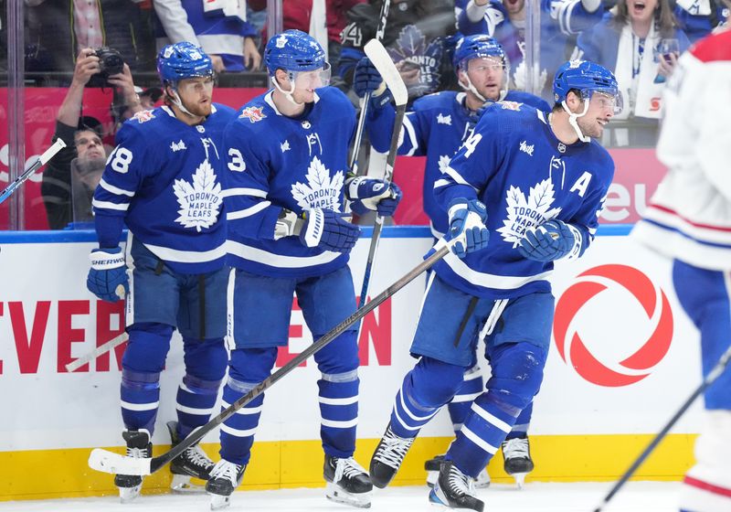 Oct 11, 2023; Toronto, Ontario, CAN; Toronto Maple Leafs center Auston Matthews (34) celebrates scoring his third goal of the game against the Montreal Canadiens during the third period at Scotiabank Arena. Mandatory Credit: Nick Turchiaro-USA TODAY Sports