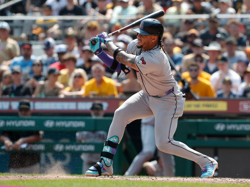 Aug 4, 2024; Pittsburgh, Pennsylvania, USA;  Arizona Diamondbacks second baseman Ketel Marte (4) drives in a run against the Pittsburgh Pirates during the sixth inning at PNC Park. Mandatory Credit: Charles LeClaire-USA TODAY Sports