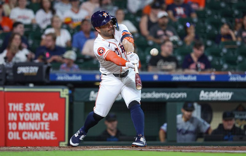 Jul 10, 2024; Houston, Texas, USA; Houston Astros second baseman Jose Altuve (27) hits a single during the first inning against the Miami Marlins at Minute Maid Park. Mandatory Credit: Troy Taormina-USA TODAY Sports