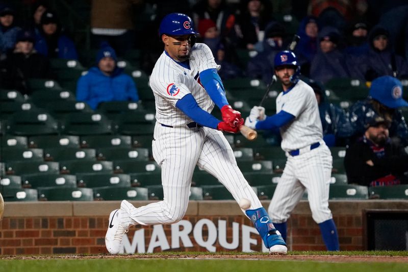 Apr 3, 2024; Chicago, Illinois, USA; Chicago Cubs third baseman Christopher Morel (5) hits a single against the Colorado Rockies during the second inning at Wrigley Field. Mandatory Credit: David Banks-USA TODAY Sports