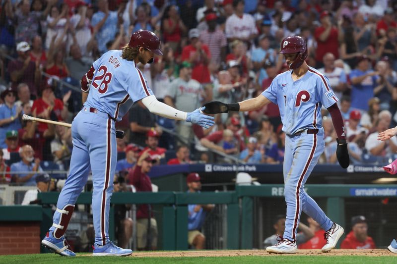 Aug 15, 2024; Philadelphia, Pennsylvania, USA; Philadelphia Phillies shortstop Trea Turner (7) is congratulated by third base Alec Bohm (28) after scoring during the fourth inning against the Washington Nationals at Citizens Bank Park. Mandatory Credit: Bill Streicher-USA TODAY Sports