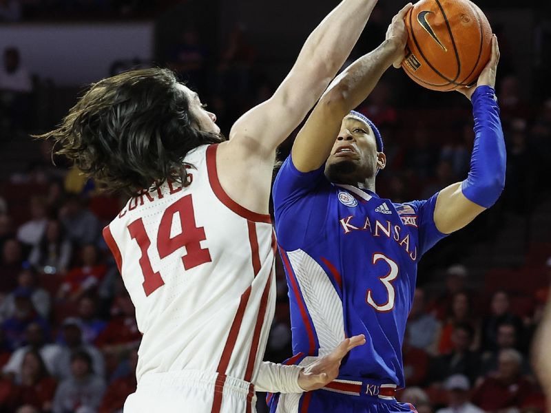 Feb 11, 2023; Norman, Oklahoma, USA; Kansas Jayhawks guard Dajuan Harris Jr. (3) shoots as Oklahoma Sooners guard Bijan Cortes (14) defends during the first half at Lloyd Noble Center. Mandatory Credit: Alonzo Adams-USA TODAY Sports