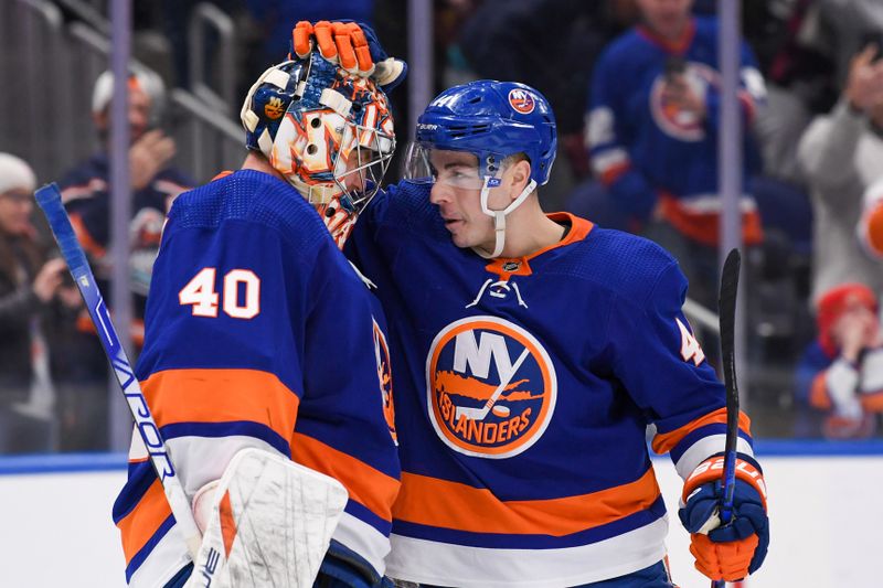 Dec 13, 2023; Elmont, New York, USA; New York Islanders center Jean-Gabriel Pageau (44) celebrates with New York Islanders goaltender Semyon Varlamov (40) after the 4-3 victory over the Anaheim Ducks after the game at UBS Arena. Mandatory Credit: Dennis Schneidler-USA TODAY Sports