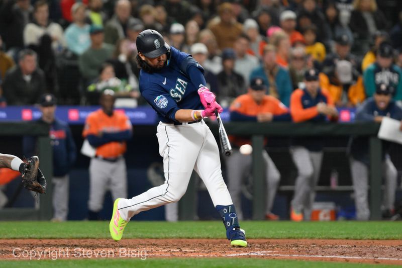 Sep 27, 2023; Seattle, Washington, USA; Seattle Mariners third baseman Eugenio Suarez (28) hits a 2-RBI single against the Houston Astros during the fourth inning at T-Mobile Park. Mandatory Credit: Steven Bisig-USA TODAY Sports