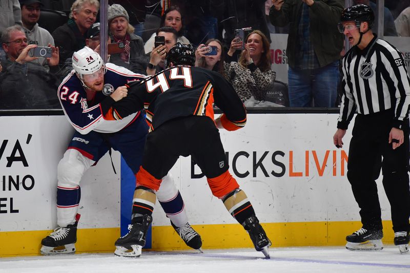 Feb 21, 2024; Anaheim, California, USA; Columbus Blue Jackets right wing Mathieu Olivier (24) fights against Anaheim Ducks left wing Ross Johnston (44) during the second period at Honda Center. Mandatory Credit: Gary A. Vasquez-USA TODAY Sports