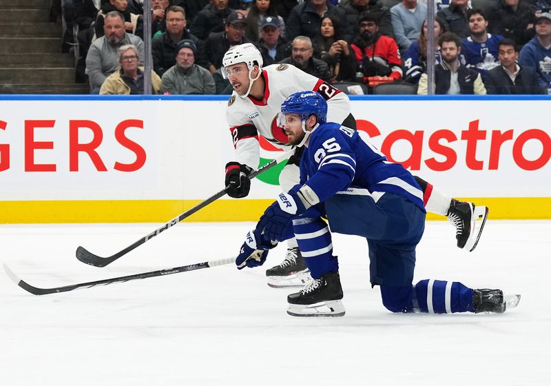 Nov 12, 2024; Toronto, Ontario, CAN; Ottawa Senators right wing Michael Amadio (22) scores past Toronto Maple Leafs defenseman Oliver Ekman-Larsson (95) during the second period at Scotiabank Arena. Mandatory Credit: Nick Turchiaro-Imagn Images