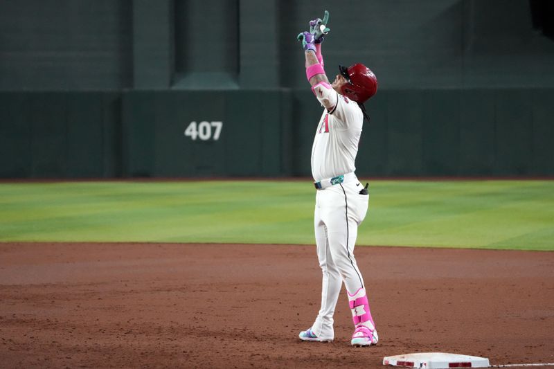 May 26, 2025; Phoenix, Arizona, USA; Arizona Diamondbacks second base Ketel Marte (4) celebrates a single against the Pittsburgh Pirates during the second inning at Chase Field. Mandatory Credit: Joe Camporeale-Imagn Images