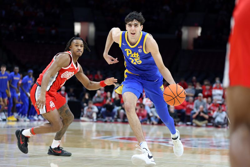 Nov 29, 2024; Columbus, Ohio, USA; Pittsburgh Panthers forward Guillermo Diaz Graham (25) drives to the basket as Ohio State Buckeyes guard Meechie Johnson Jr. (1) defends during the first half at Value City Arena. Mandatory Credit: Joseph Maiorana-Imagn Images