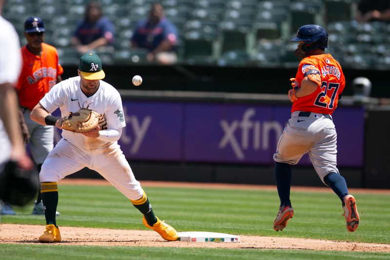 Jul 24, 2024; Oakland, California, USA; Houston Astros second baseman Jose Altuve (27) reaches base safely on a bad throw to Oakland Athletics first baseman Seth Brown (15) during the fifth inning at Oakland-Alameda County Coliseum. Mandatory Credit: D. Ross Cameron-USA TODAY Sports