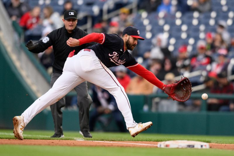 Apr 4, 2024; Washington, District of Columbia, USA; Washington Nationals first baseman Joey Gallo (24) reaches for a ball during the fifth inning against the Pittsburgh Pirates at Nationals Park. Mandatory Credit: Reggie Hildred-USA TODAY Sports