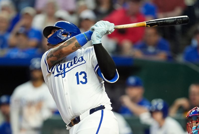 Aug 10, 2024; Kansas City, Missouri, USA; Kansas City Royals first baseman Salvador Perez (13) hits a home run during the seventh inning against the St. Louis Cardinals at Kauffman Stadium. Mandatory Credit: Jay Biggerstaff-USA TODAY Sports