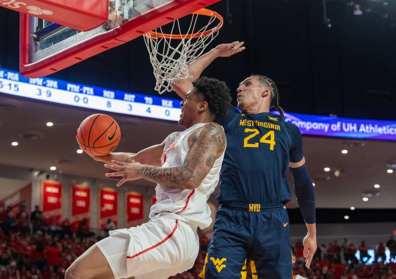 Jan 6, 2024; Houston, Texas, USA; Houston Cougars guard Ramon Walker Jr. (3) scores on a revers layup against West Virginia Mountaineers forward Patrick Suemnick (24) in the first half  at Fertitta Center. Mandatory Credit: Thomas Shea-USA TODAY Sports